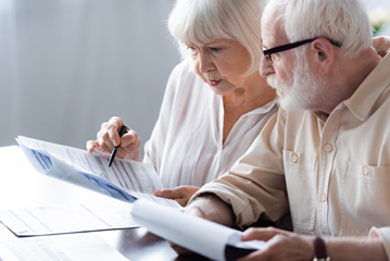 senior couple looking over policies