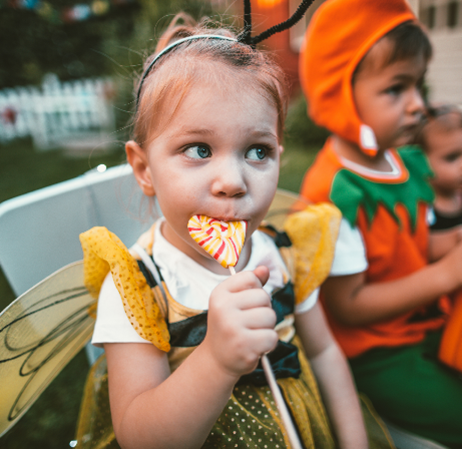 little girl eating lollipop